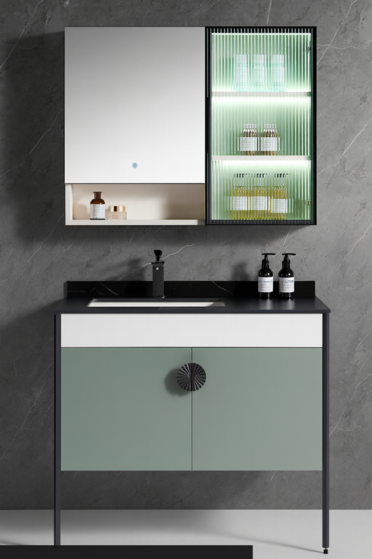 Two-tone vanity with pastel-green doors, sculpted centre pull, and matte black frame