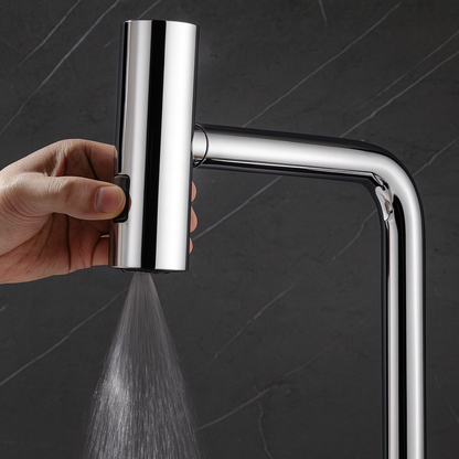 Chrome shower head with water spray against a dark background