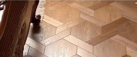 Carvaux parquet flooring in honey oak variation, highlighting interlocking geometric layout – SAIBA Homes.
