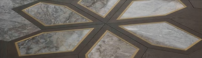 Close-up of Castone luxury flooring showing marble inserts framed by walnut/oak veneer shapes — SAIBA Homes.