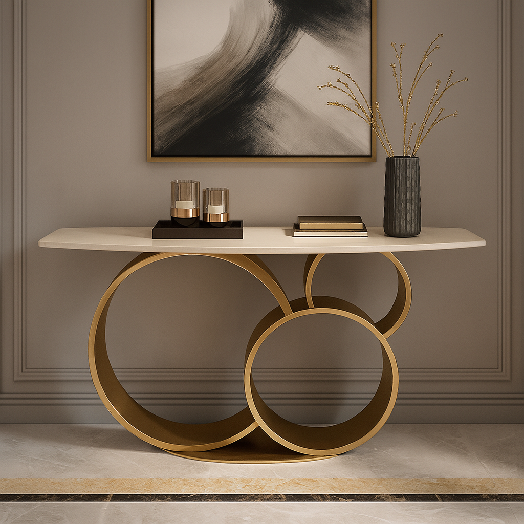 Modern console table with marble top and gold circular legs against a gray wall with abstract art.