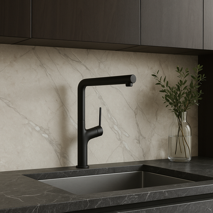 Black faucet on a kitchen sink with marble backsplash