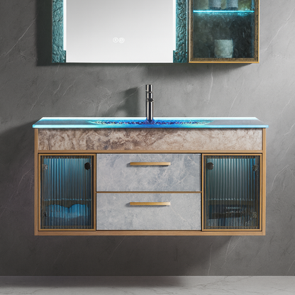 Floating vanity with glass countertop, textured stone-effect cabinet fronts, gold hardware, and fluted glass side doors beneath an illuminated mirror cabinet – SAIBA Homes.