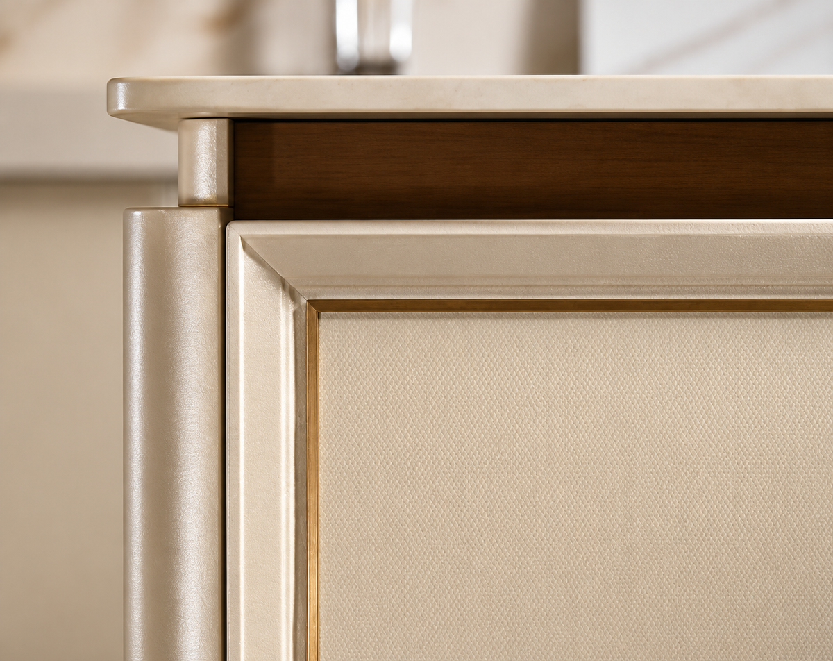 Close-up detail of a modern cabinet or sideboard corner, showing a brushed gold metal frame, a textured beige fabric front panel, and a dark wood shelf above.