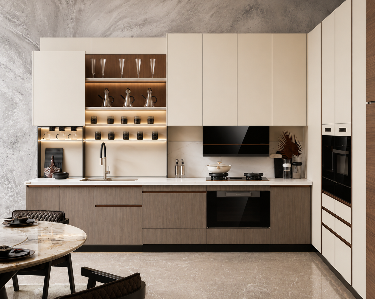 A modern kitchen cabinetry set with cream-colored flat-panel upper cabinets, light wood lower cabinets, white countertops, built-in black appliances, and open shelving with glassware, shown in a styled interior scene.
