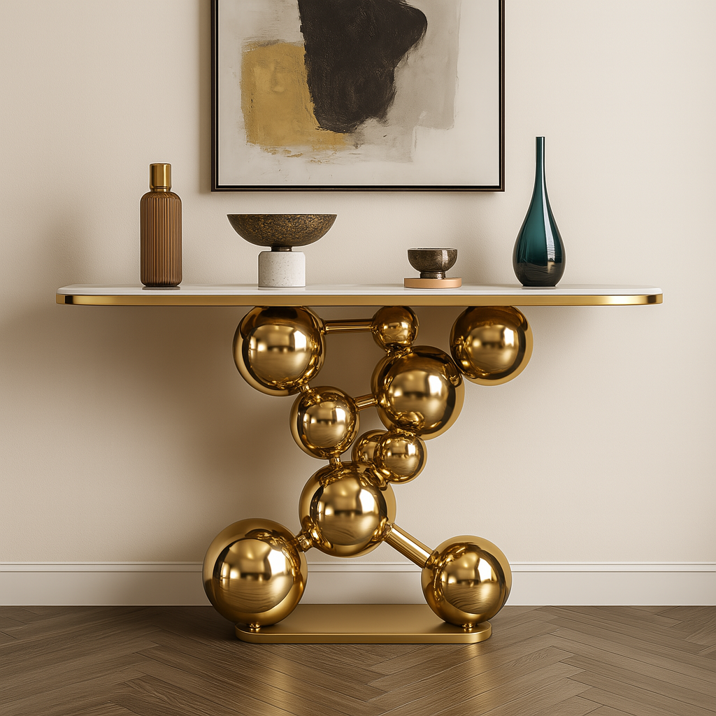 Modern console table with gold spherical design against a neutral wall.