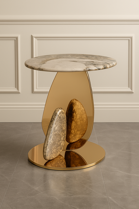 Modern side table with marble top and gold base against a neutral wall.