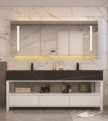 Floating double vanity with black marble-look countertop, LED mirror cabinet, matte black faucets, and open shelf storage – SAIBA Homes.