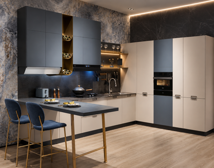 A modern L-shaped kitchen featuring dark gray and cream cabinets, a central island with a dark countertop and gold legs, two blue bar stools, and a marble-patterned backsplash.