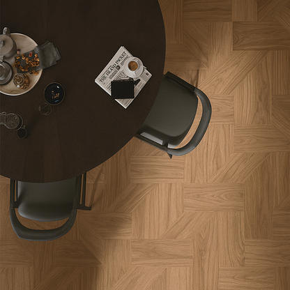Geometric engineered hardwood flooring in warm walnut/oak tones arranged in interlocking pattern – SAIBA Homes
