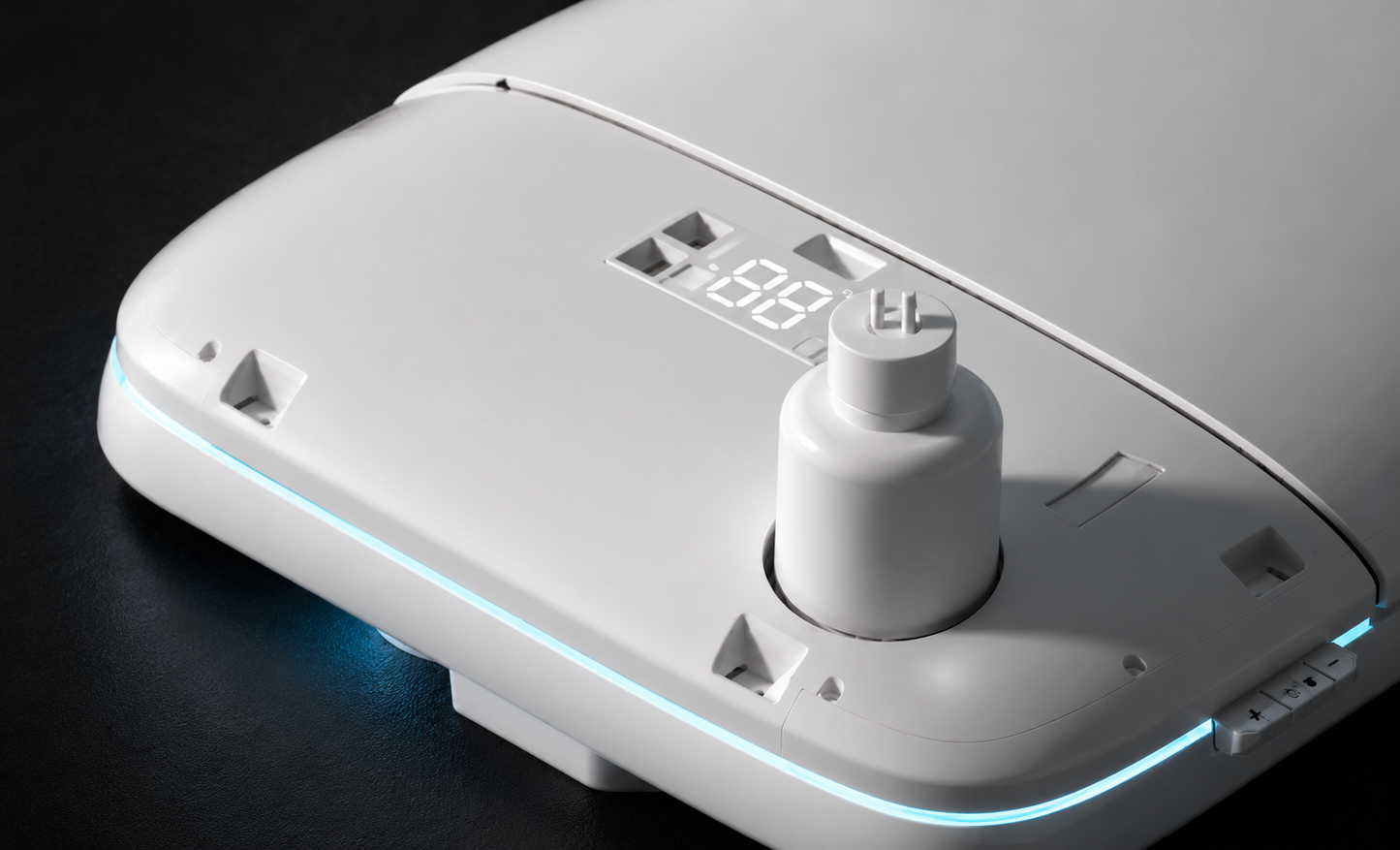 A close-up of a white electronic device with a central cylindrical knob, a small digital display reading 18:18, and a thin blue LED light strip along the edge, set against a dark background.