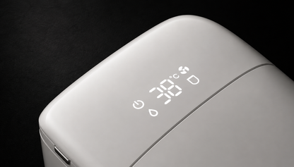 Close-up of a white electronic device with a glossy finish, featuring a digital LED display showing 38 degrees Celsius and status icons, set against a dark background.
