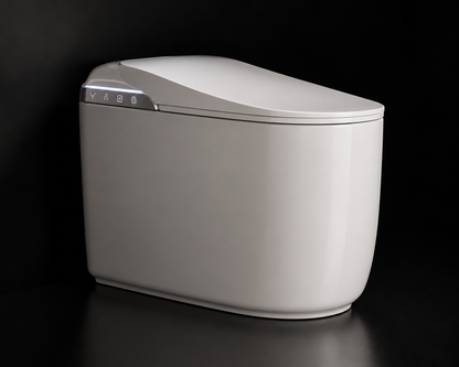 A modern, compact smart toilet with a white body and lid, featuring a sleek control panel on the front left, set against a dark black background.