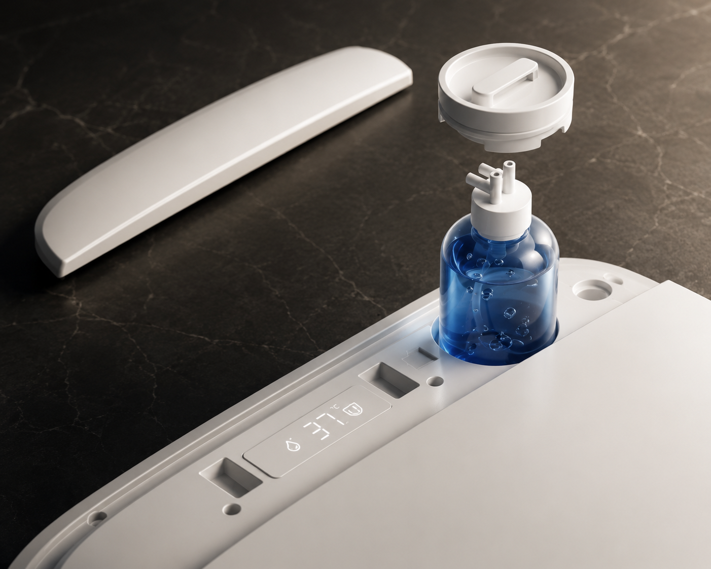 A close-up of a white appliance accessory set on a dark marble surface, including a curved white cover piece, a small blue bottle with a white cap, and a white plastic insert with printed symbols.