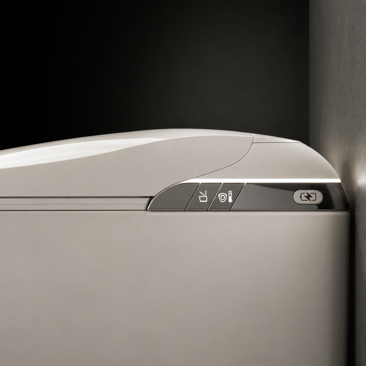Close-up of a modern compact refrigerator or freezer door showing the top control panel with three buttons and icons, in a warm light gray finish against a dark background.