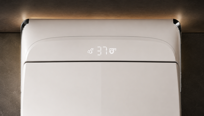 Close-up of a white modern wall-mounted appliance, likely a humidifier or heater, with a small digital temperature display showing 37 degrees Celsius, set against a dark textured wall with warm ambient lighting.