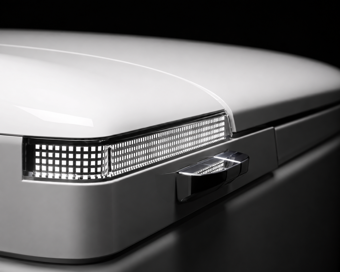 Close-up of a white vehicle body panel showing a slim rectangular LED light strip and a chrome side handle against a dark background.