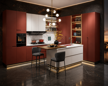 A modern kitchen interior with tall cabinetry in a muted brick red color, white upper and island cabinets, dark marble flooring, two bar stools, pendant lights, and built-in appliances.