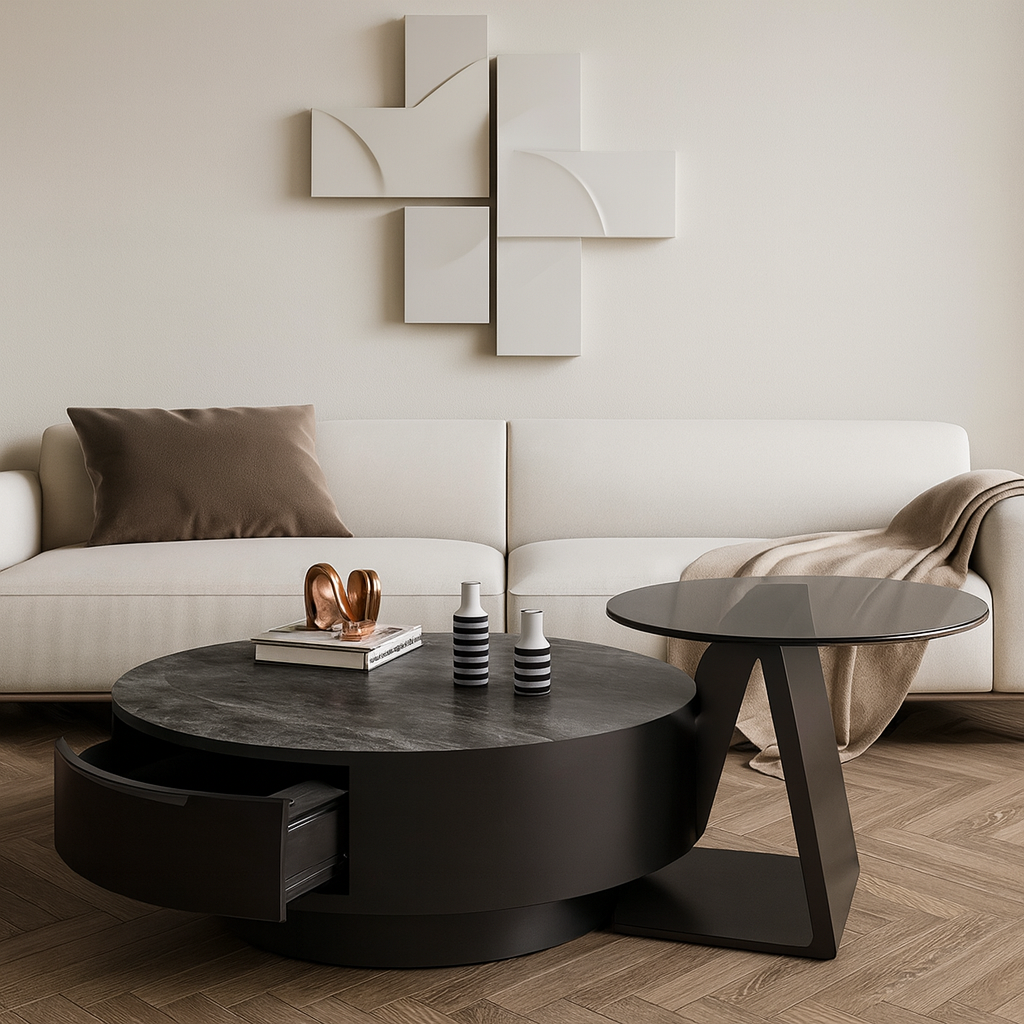 Modern living room with a white sofa, round black coffee table, and abstract wall art.