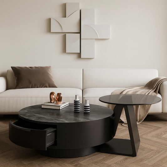 Modern living room with a white sofa, round black coffee table, and abstract wall art.