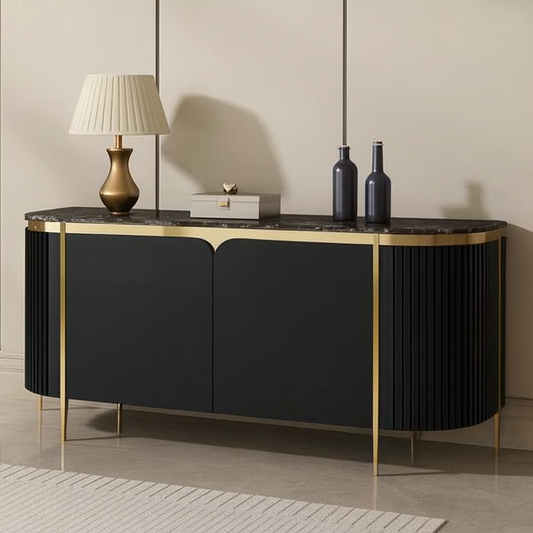 Black and gold cosole with decorative items against a beige wall.
